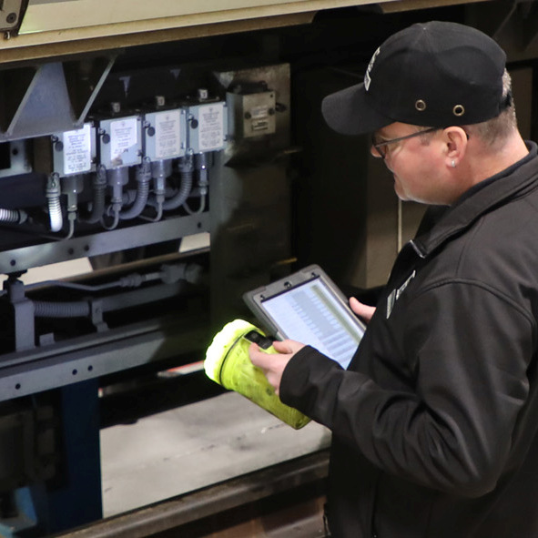 Photo of a sho floor worker by an underframe